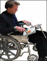 Photograph of a man in a wheelchair using an assistitve technology reading device